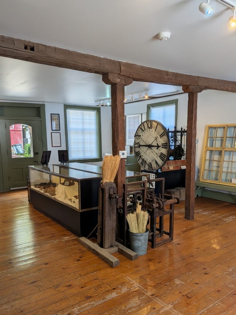 Inside the Wagner/Bentel Haus: hand-hewn beams, a large clock face, display cases and old wooden tools