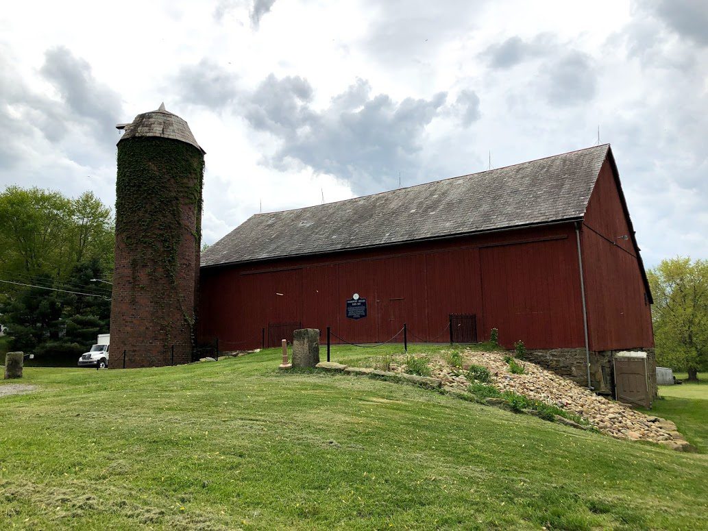 The red Harmonist Barn and its brick silo on Mercer Road